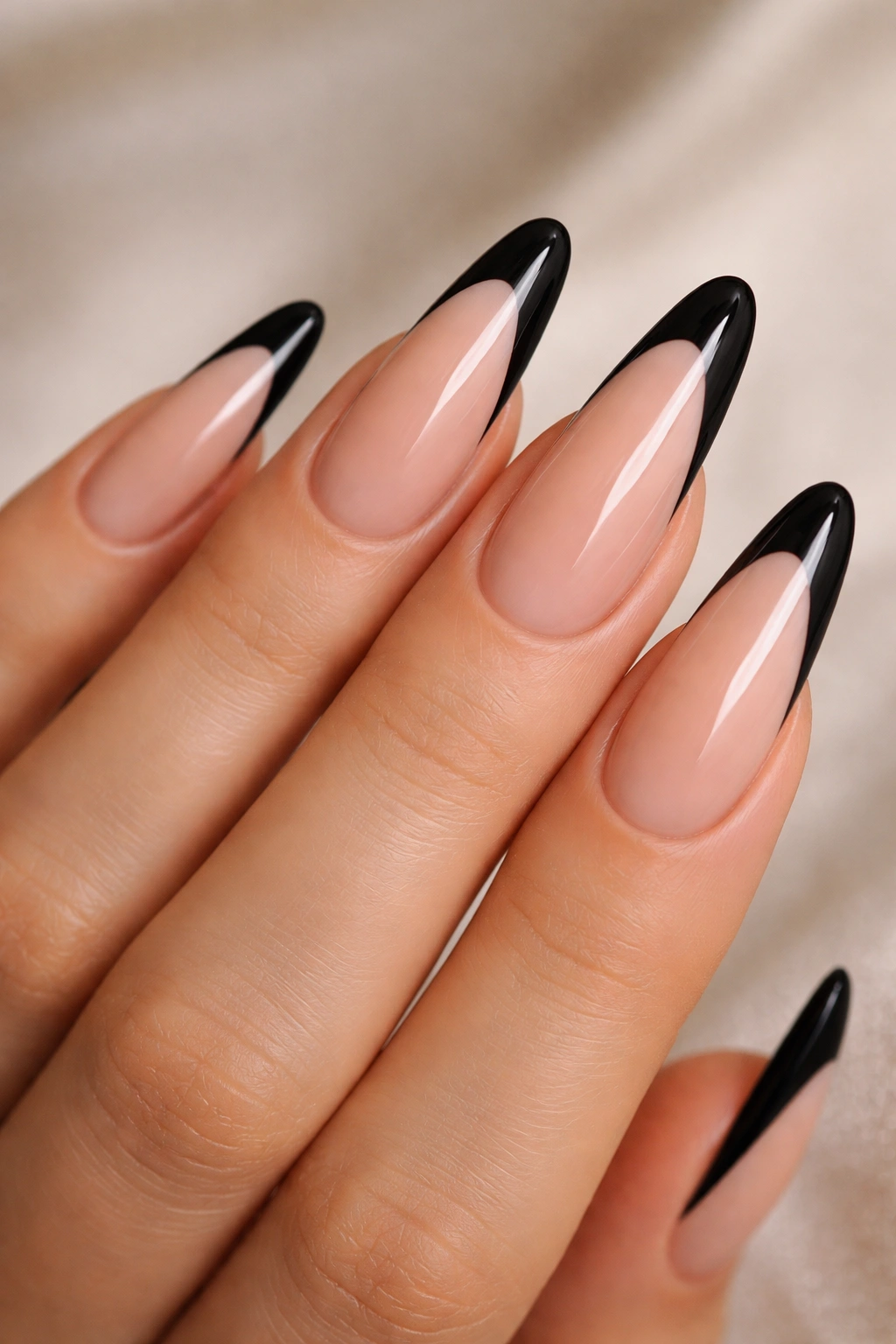Almond nails with black French tips on nude base