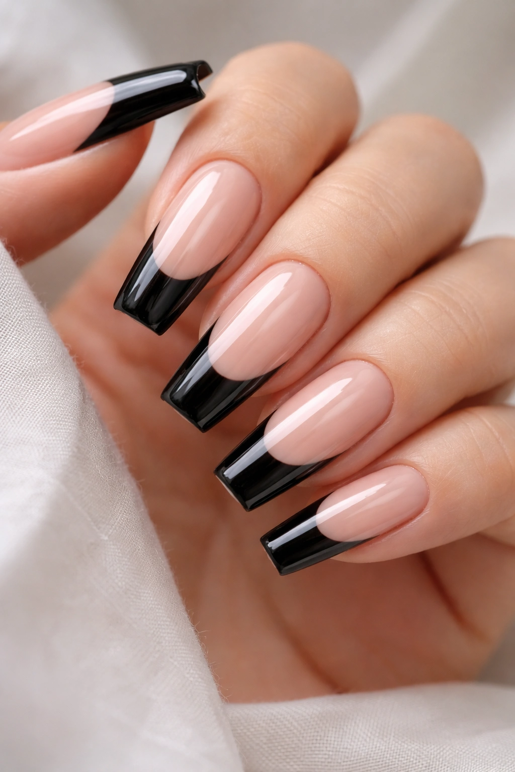 Close-up of black French tips with wet-gloss on coffin nails