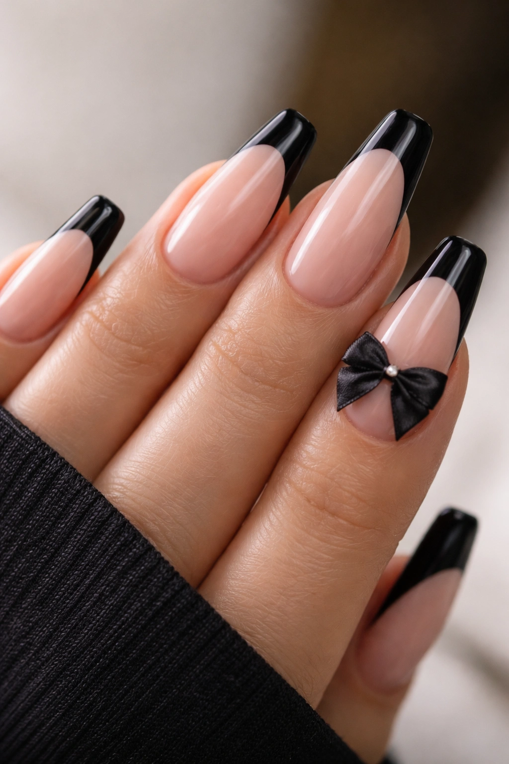 Black French coffin nails with a satin bow accent on one nail
