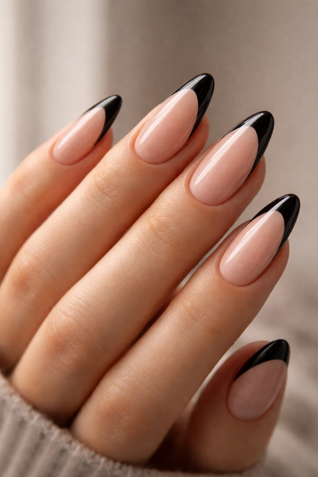 Almond nails with sheer pink base and black French tips