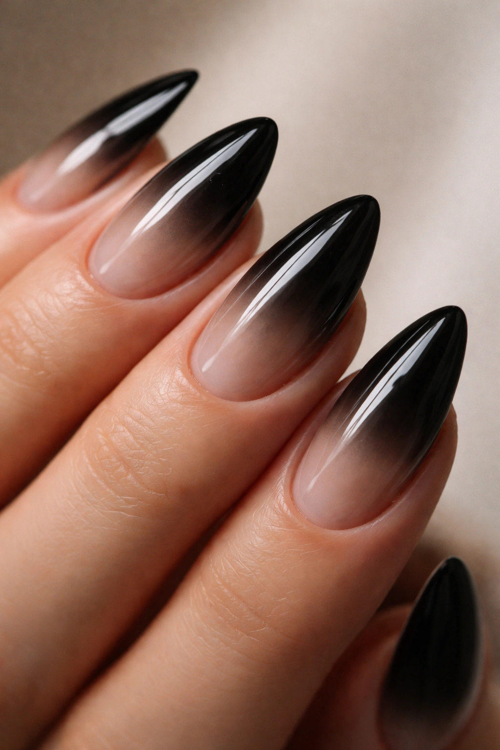 Almond nail with translucent black glaze over sheer nude base