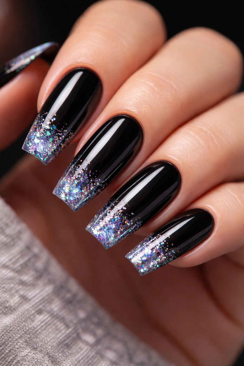 Black coffin nails with holographic glitter tips at the free edge