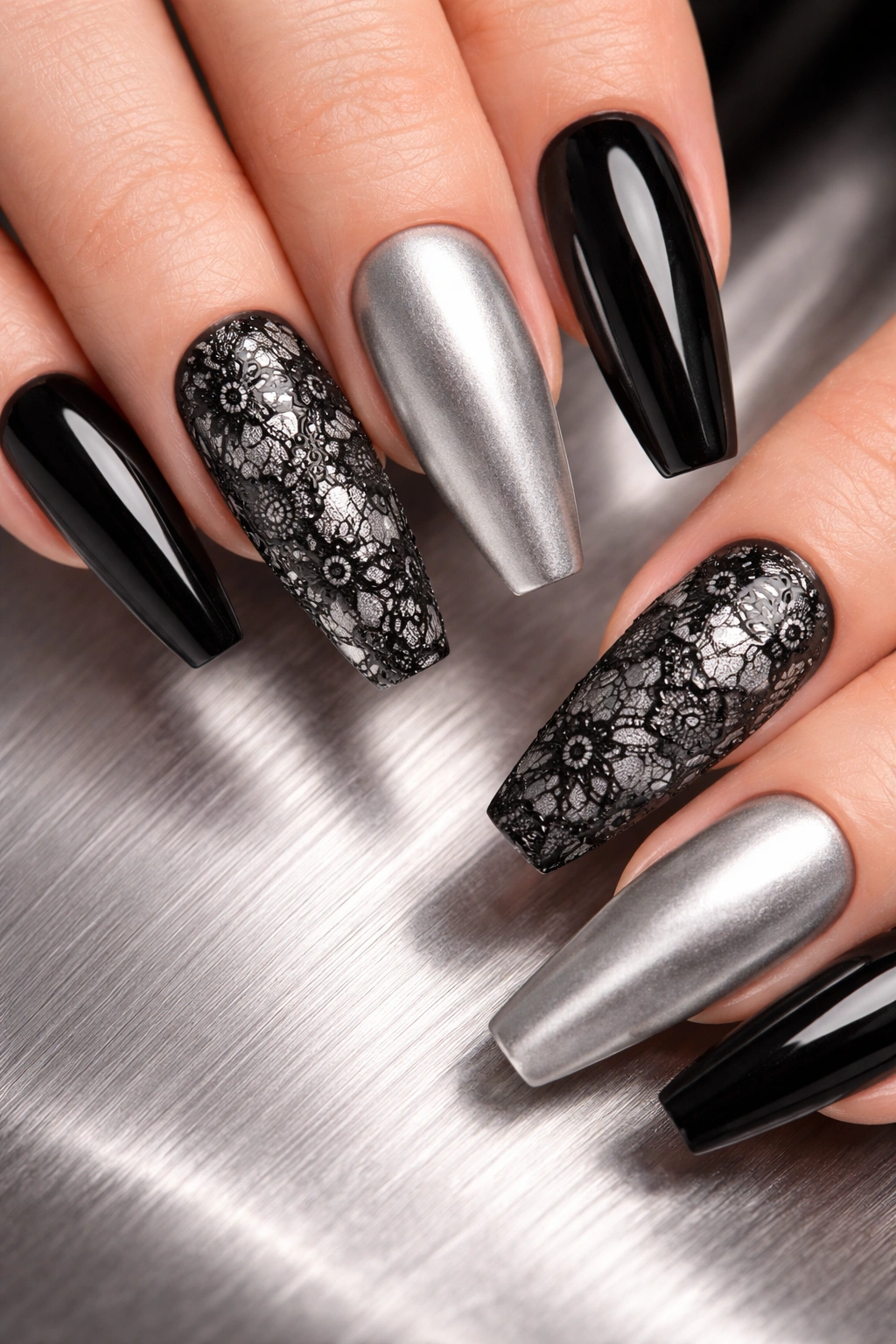 Close-up of coffin nails with black lace on a brushed silver background