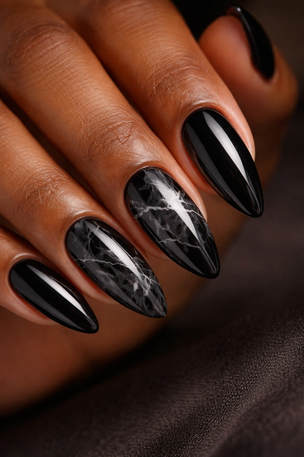 Close-up of black marble nails with soft gray veins