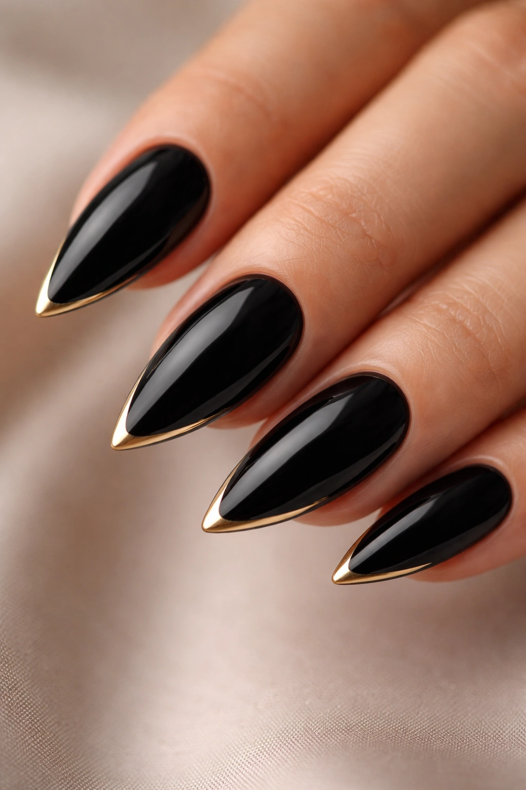 Black almond nails with razor-thin gold tips
