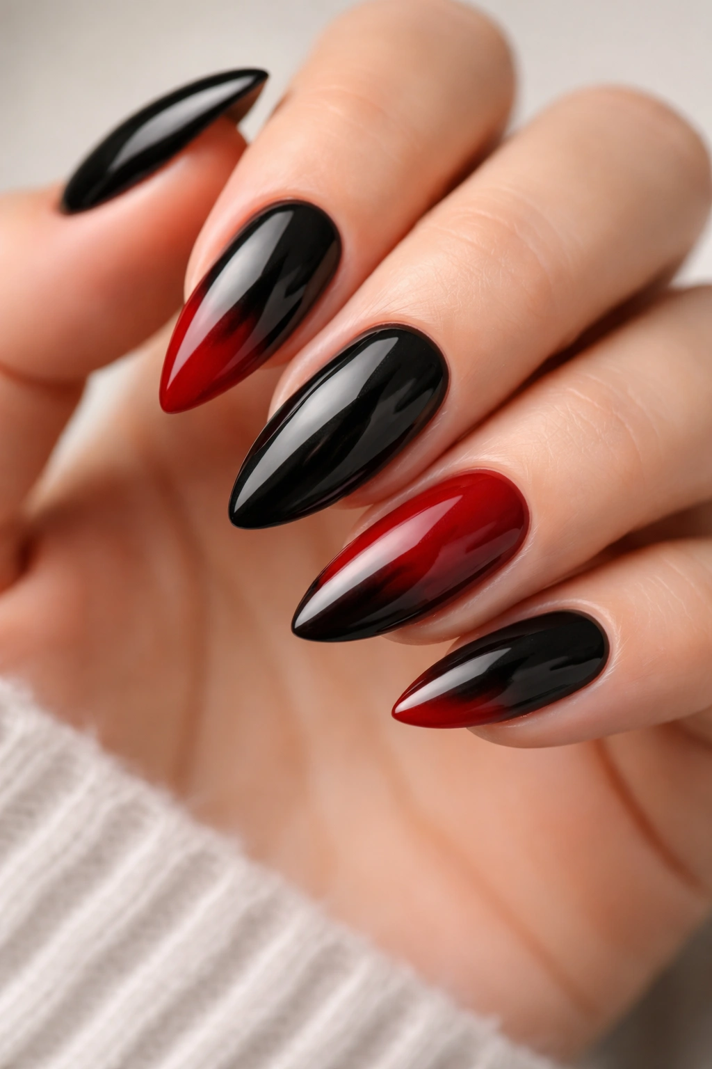 Almond nails in black and deep red with controlled color placement