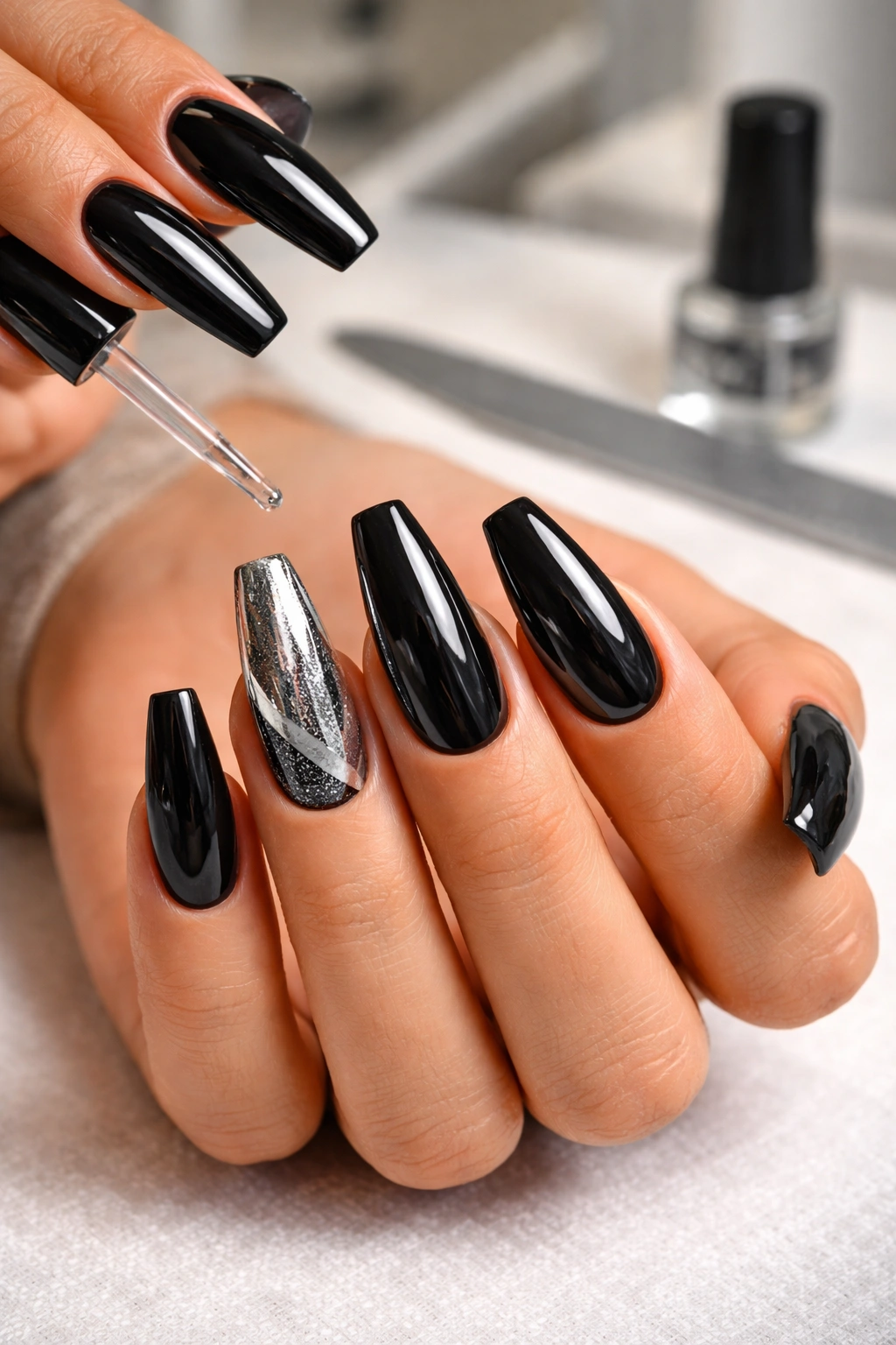 Close-up of black and silver coffin nails with glossy finish