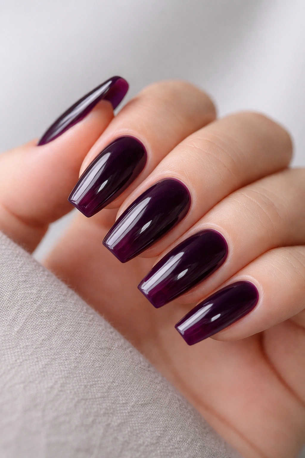 Close-up of blackberry jelly ballerina nails showing translucent depth and glassy finish