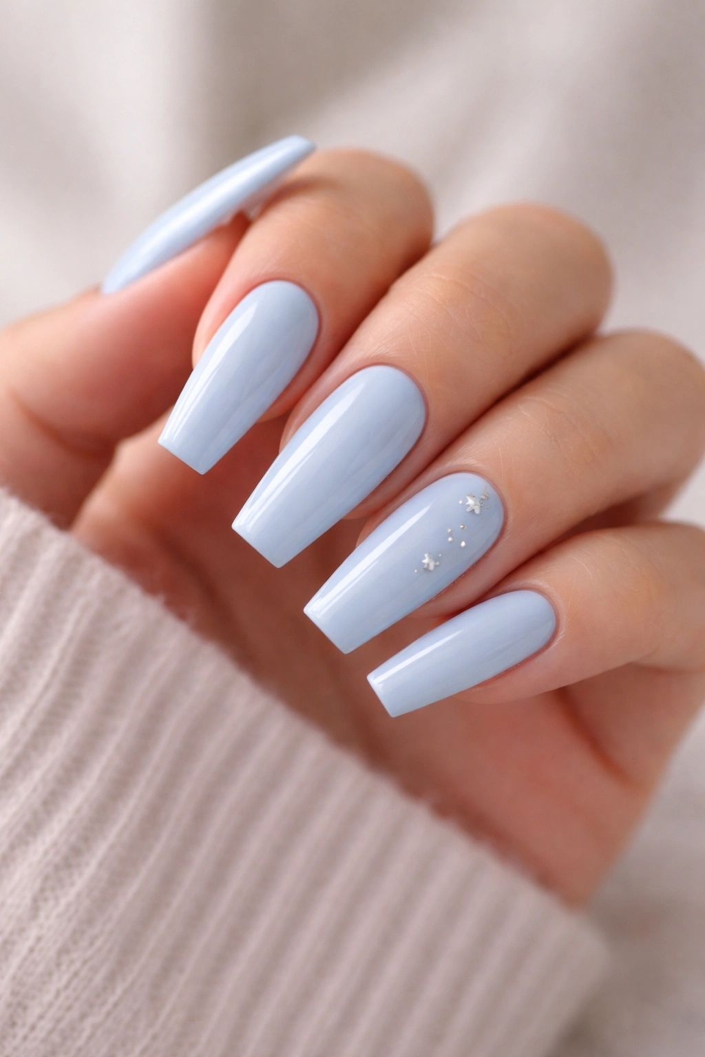 Pale sky blue coffin nails with small silver stars on accent nails