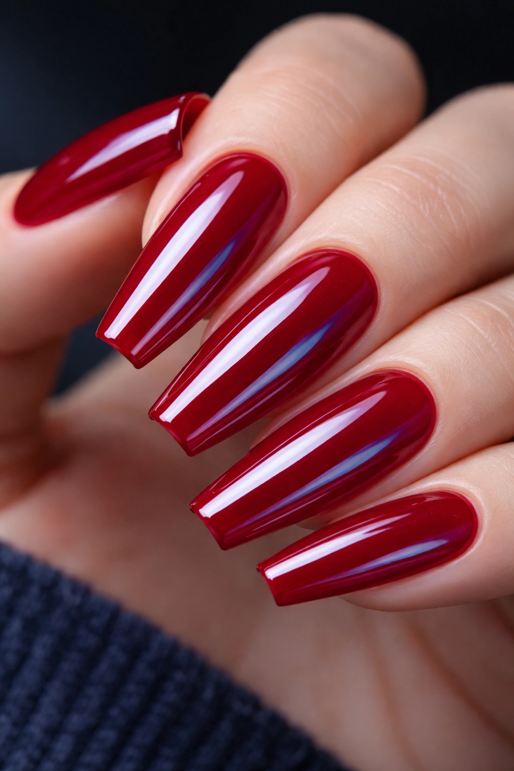 Close-up of blue-red coffin nails with high-gloss blue undertone