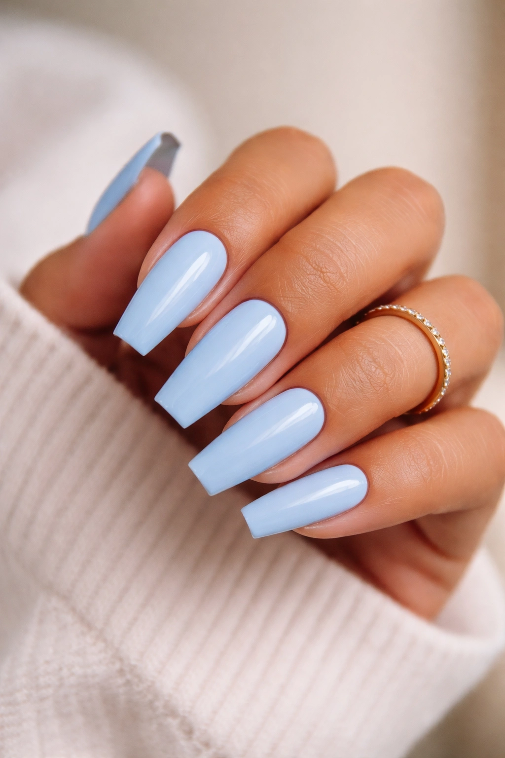 Nails painted in cool baby blue showing undertone match with skin tone