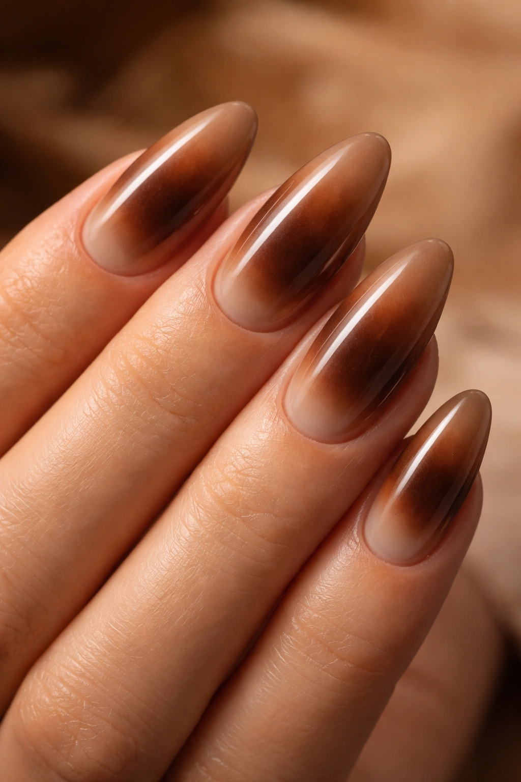 Almond nails with brown aura gradient from center to edges