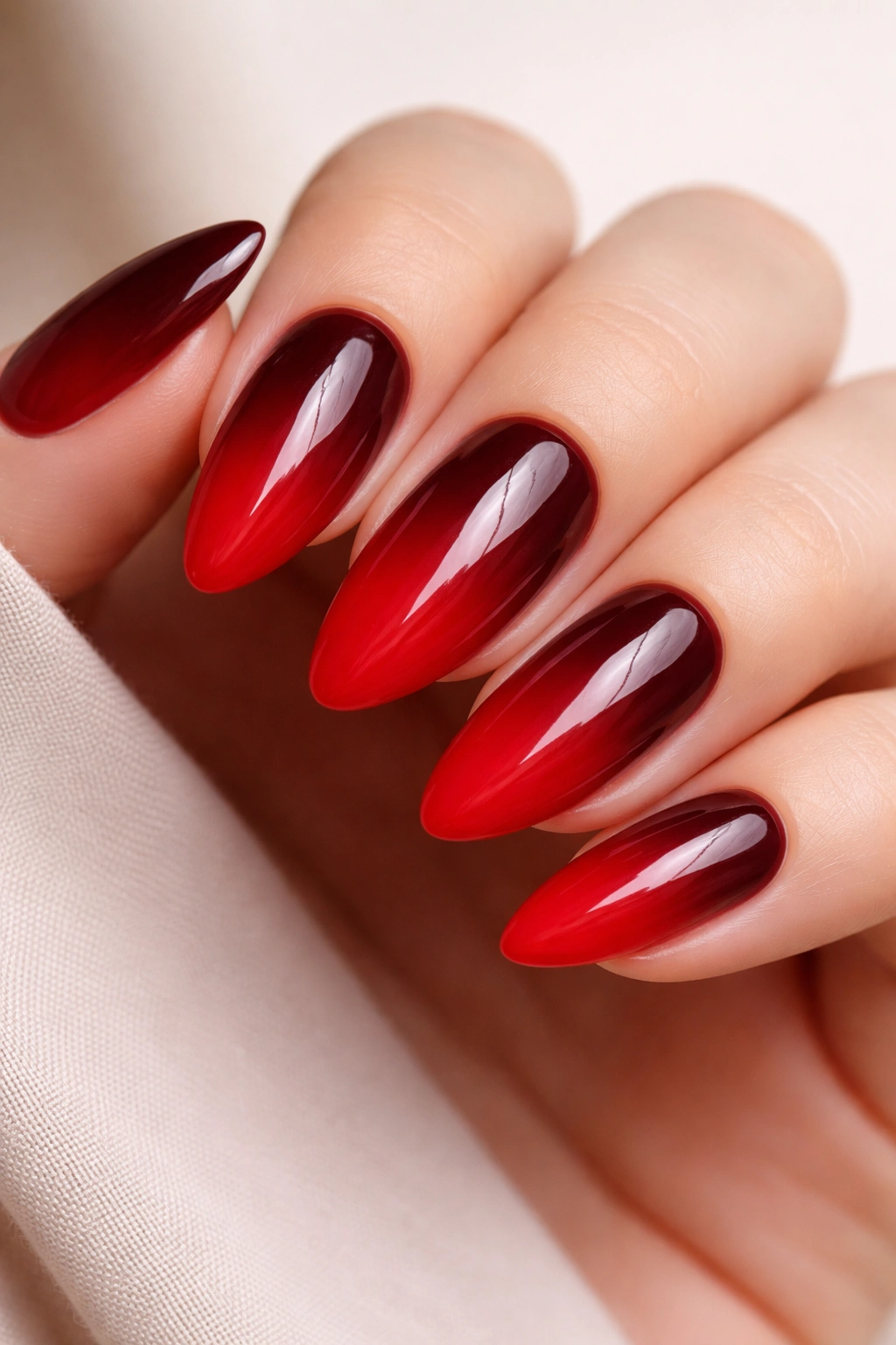 Almond nails with burgundy-to-cherry gradient and glossy finish