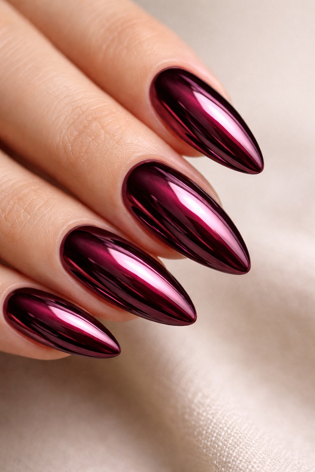 Chrome burgundy almond nails with mirror finish