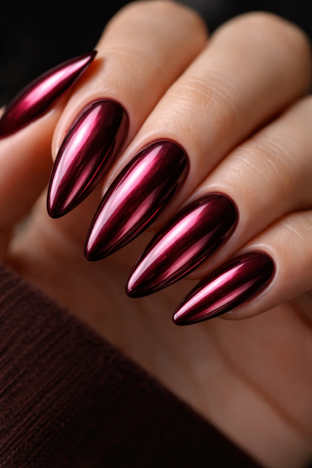 Burgundy nails with chrome finish on almond shape
