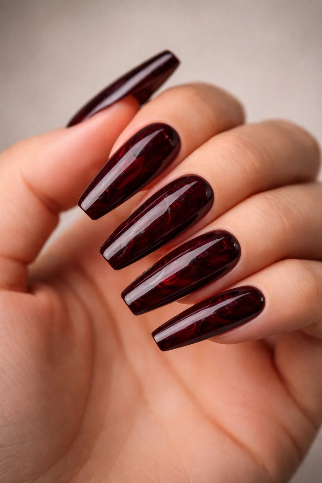 Close-up of burgundy marble coffin nails with black veins on coffin nails