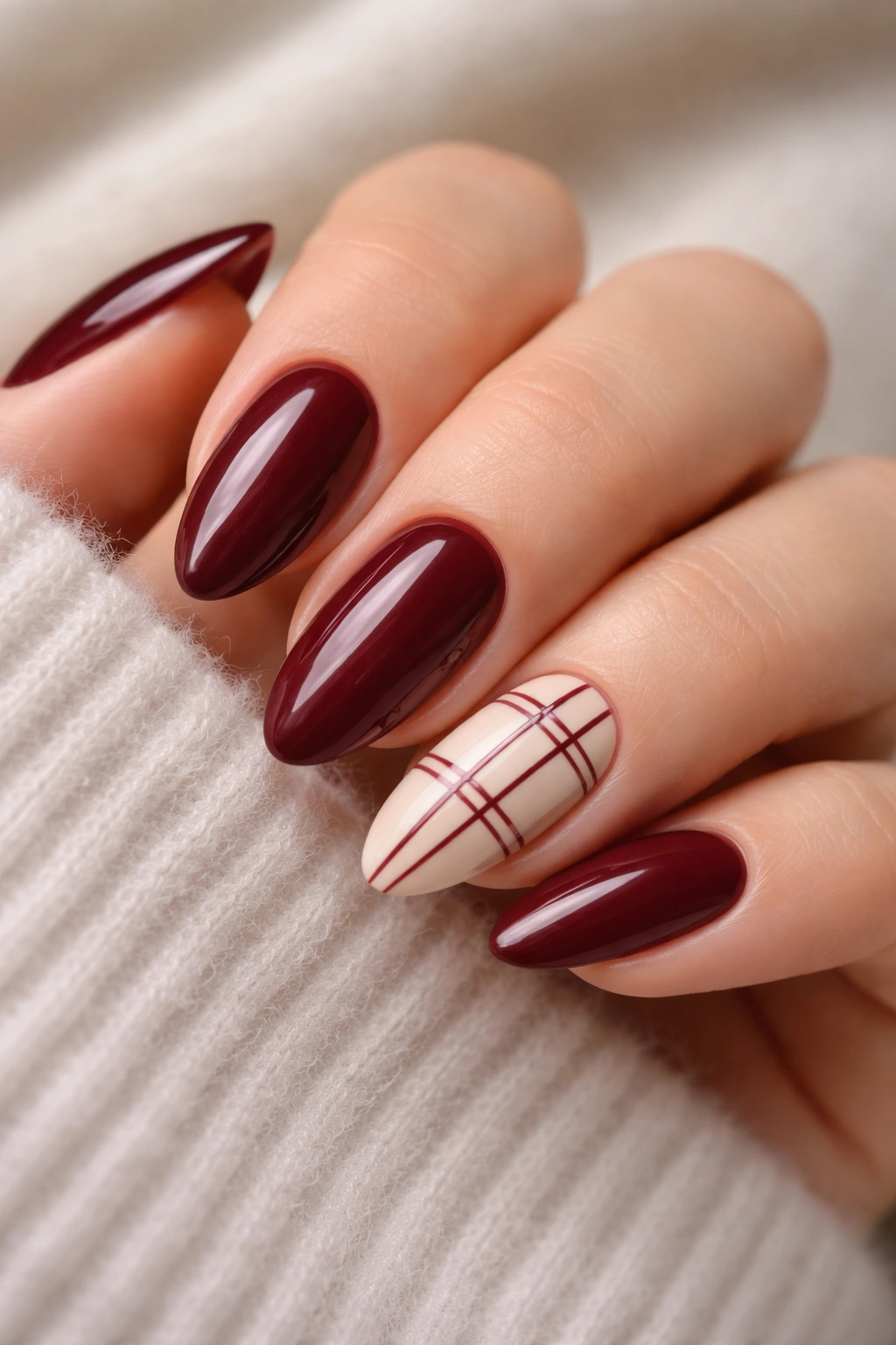 Almond nails with burgundy grid pattern on accent nail