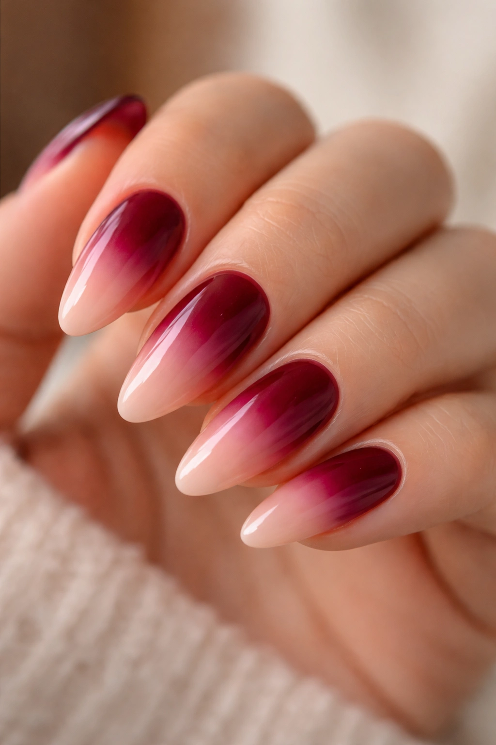 Ombré burgundy nails fading into blush on almond nails