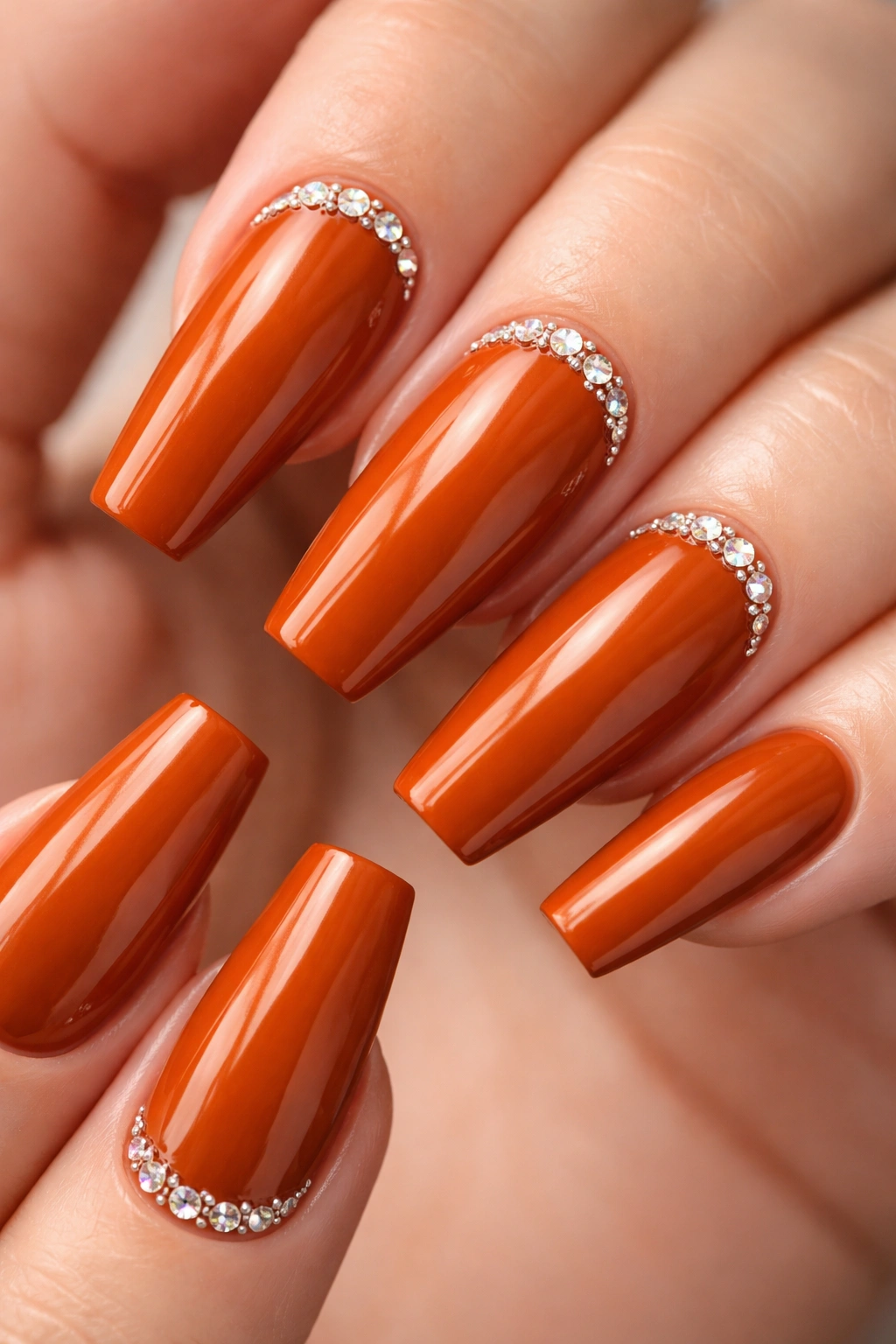 Close-up of burnt orange coffin nails with tiny cuticle crystals