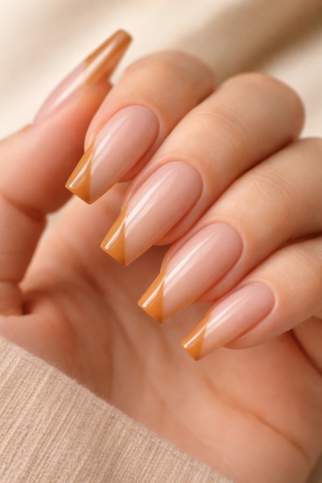Coffin nails with a caramel side-French diagonal on a nude base