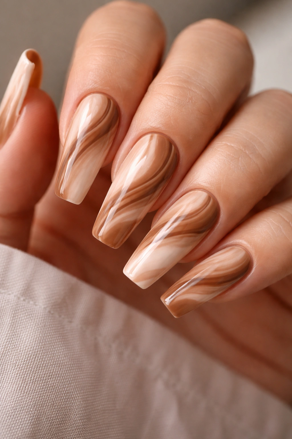 Coffin nails with caramel swirl patterns on all ten nails