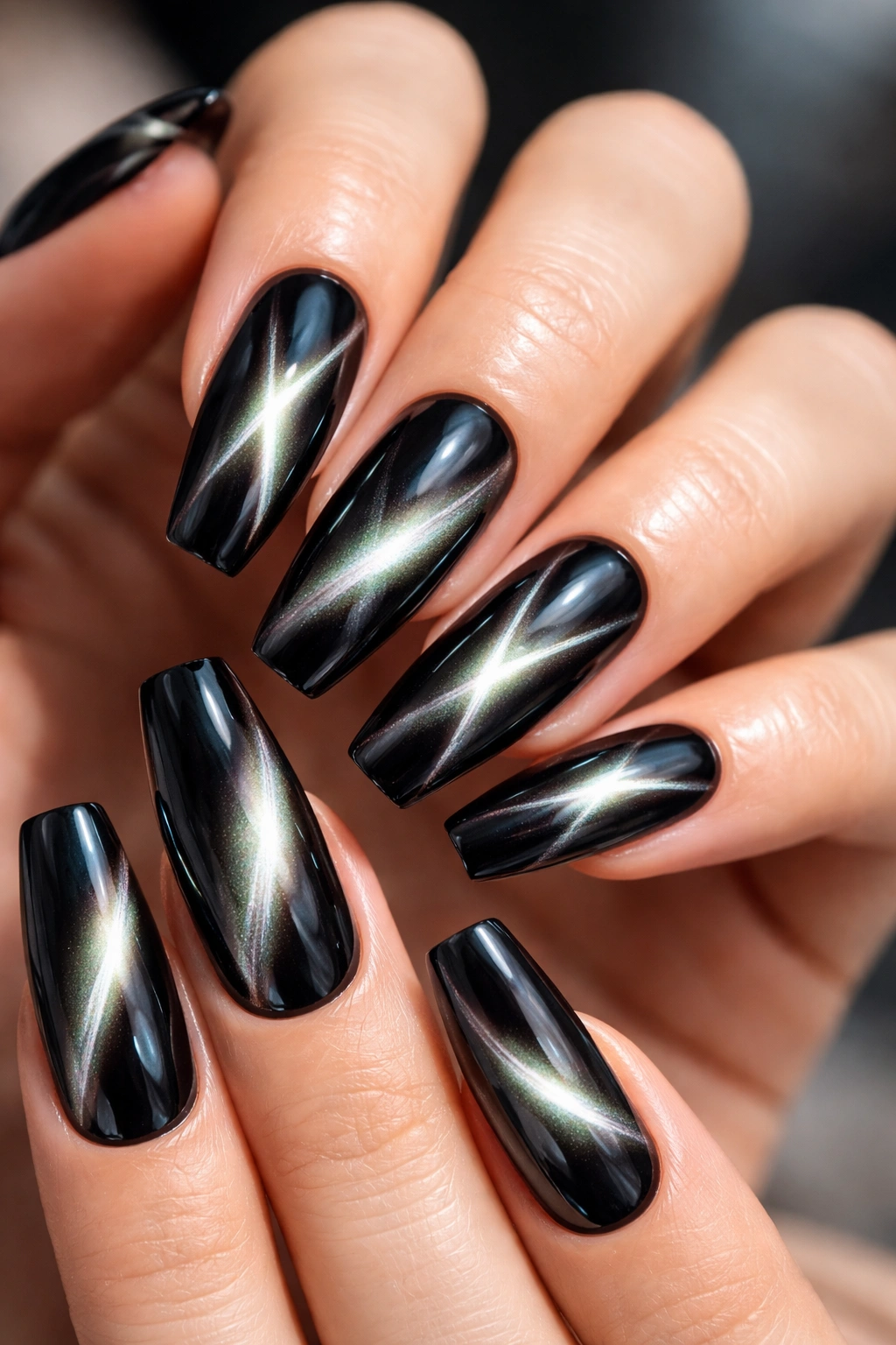 Cat-eye bands on black chrome coffin nails showing shifting glow