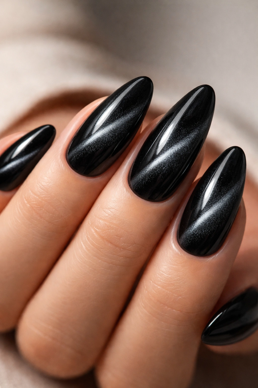 Almond nails with velvet cat-eye shimmer and diagonal stripe