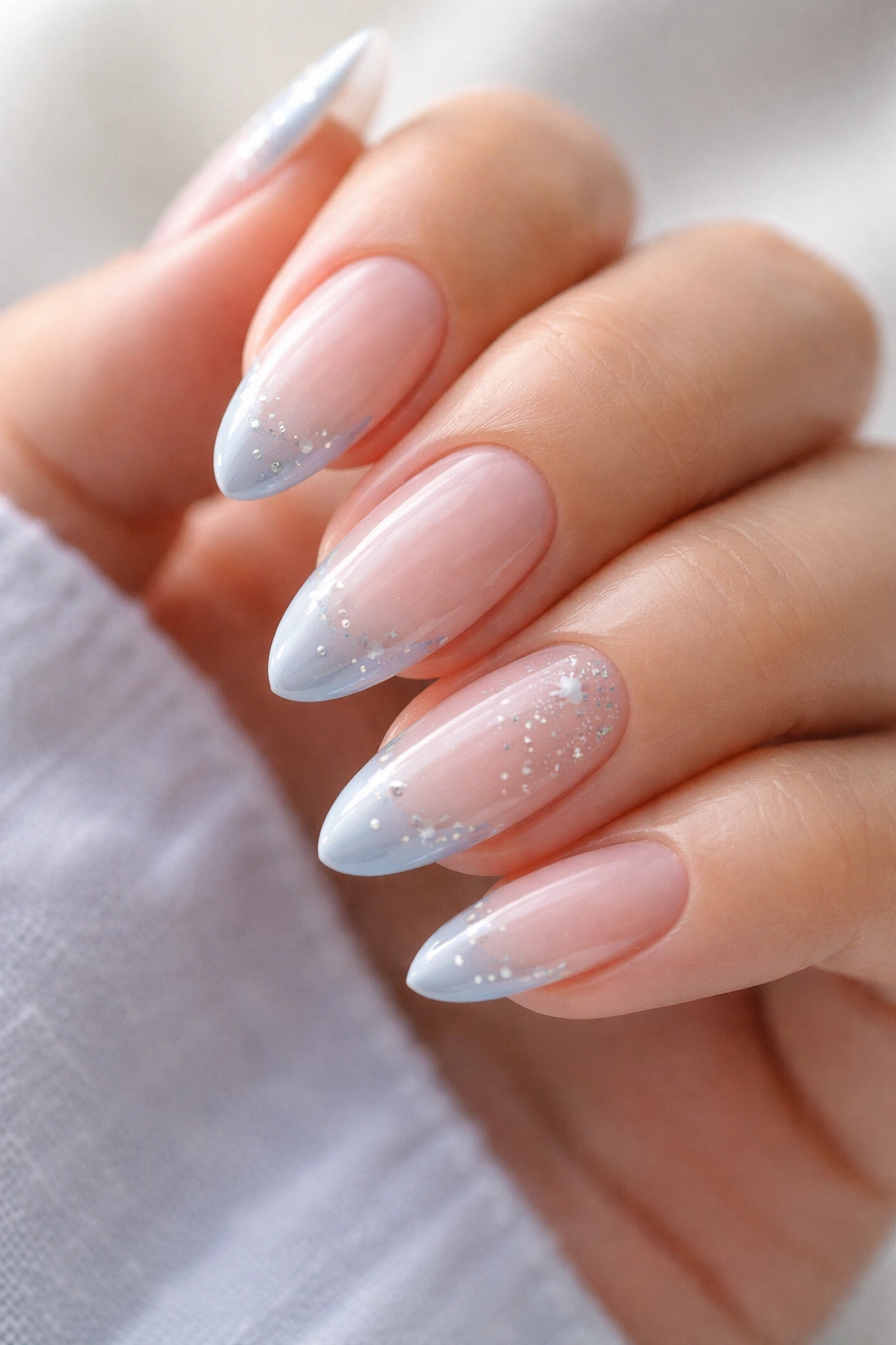 Almond nails with celestial stars decorating the French tip