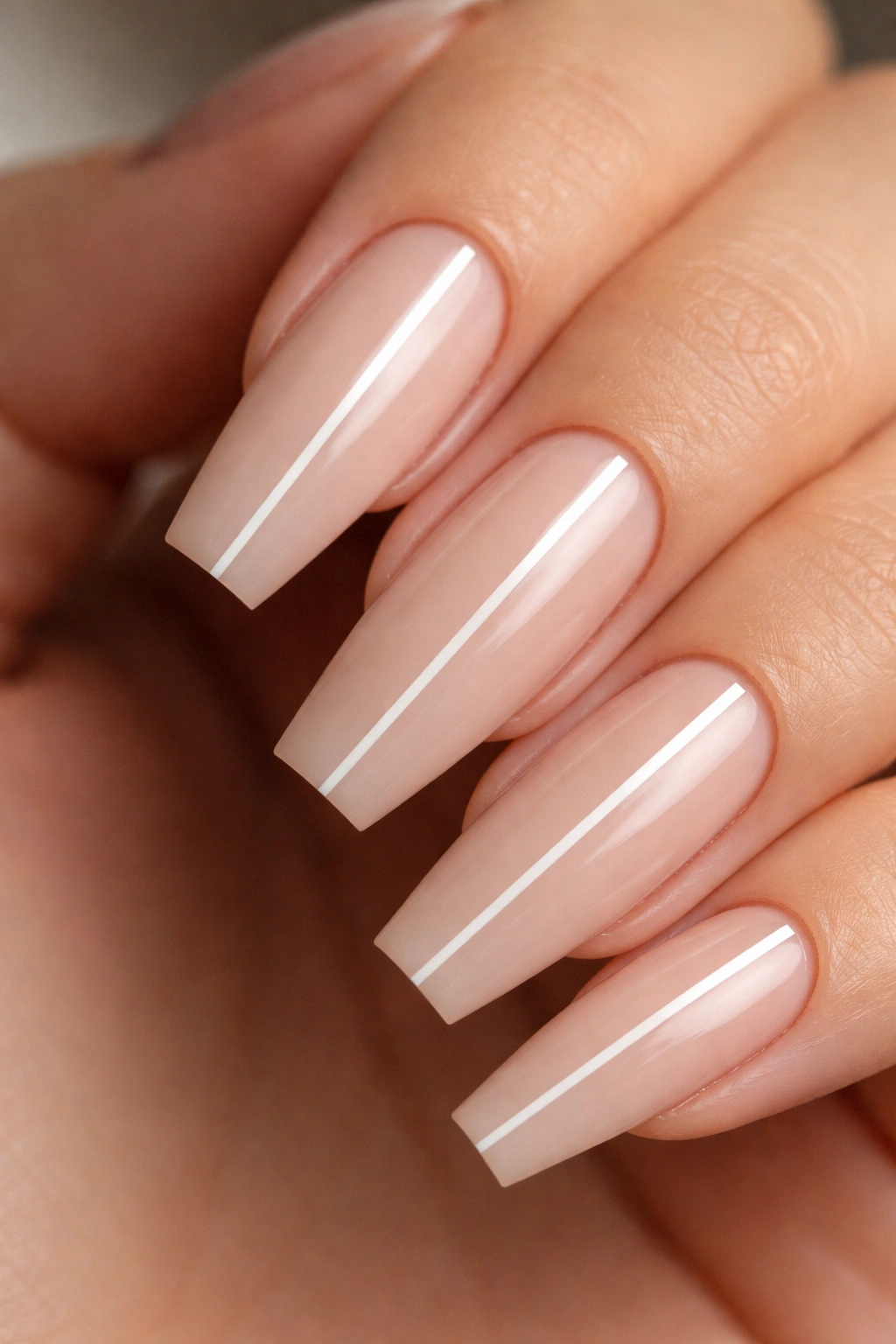 Nude coffin nails with a single hair-thin center stripe