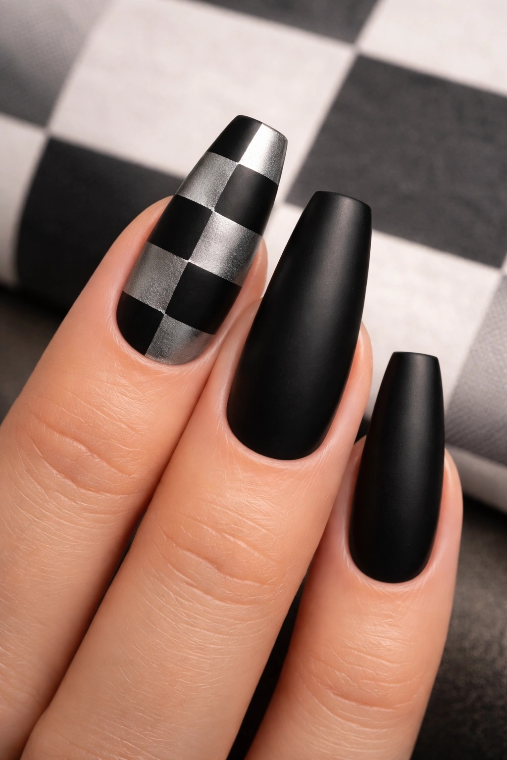 Close-up of coffin nails with split black and silver checkerboard pattern