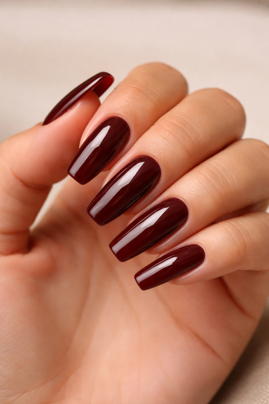 Close-up of cherry mocha coffin nails with a high-gloss finish