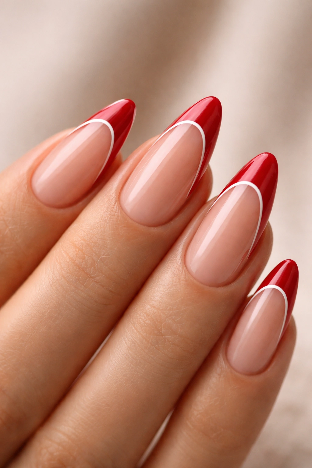 Almond nail with cherry red French tip, white lining, and negative space