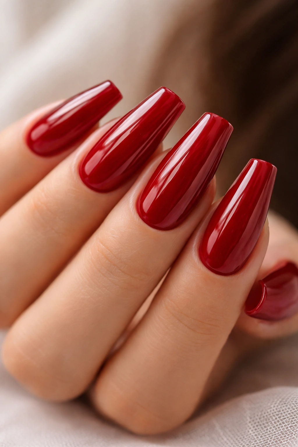 Glossy cherry red coffin nails close-up