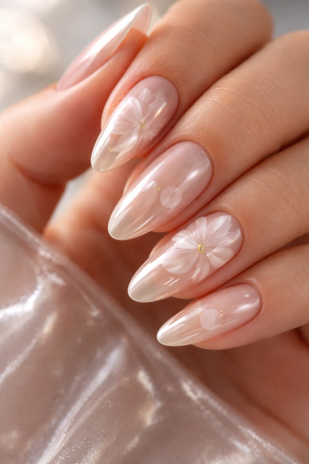 Nude chrome nails with translucent petal overlays