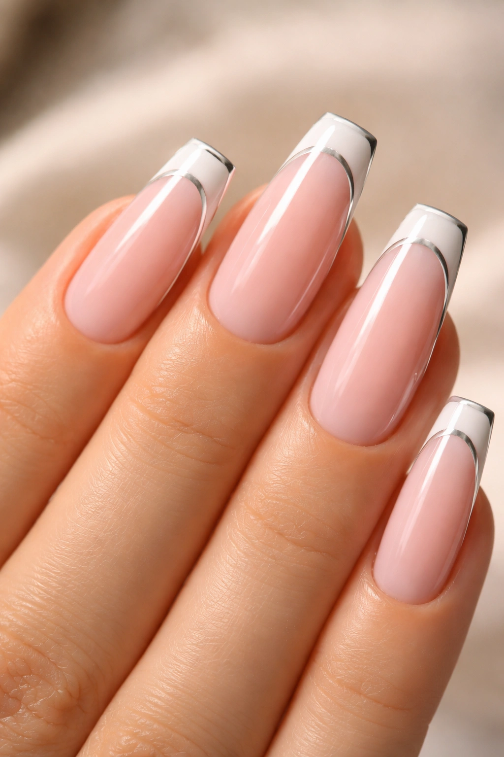Nails with pink base, white tips, and chrome outline along the edge