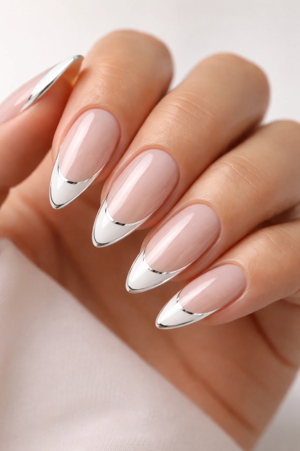 Almond nails with white French tips and a thin chrome outline