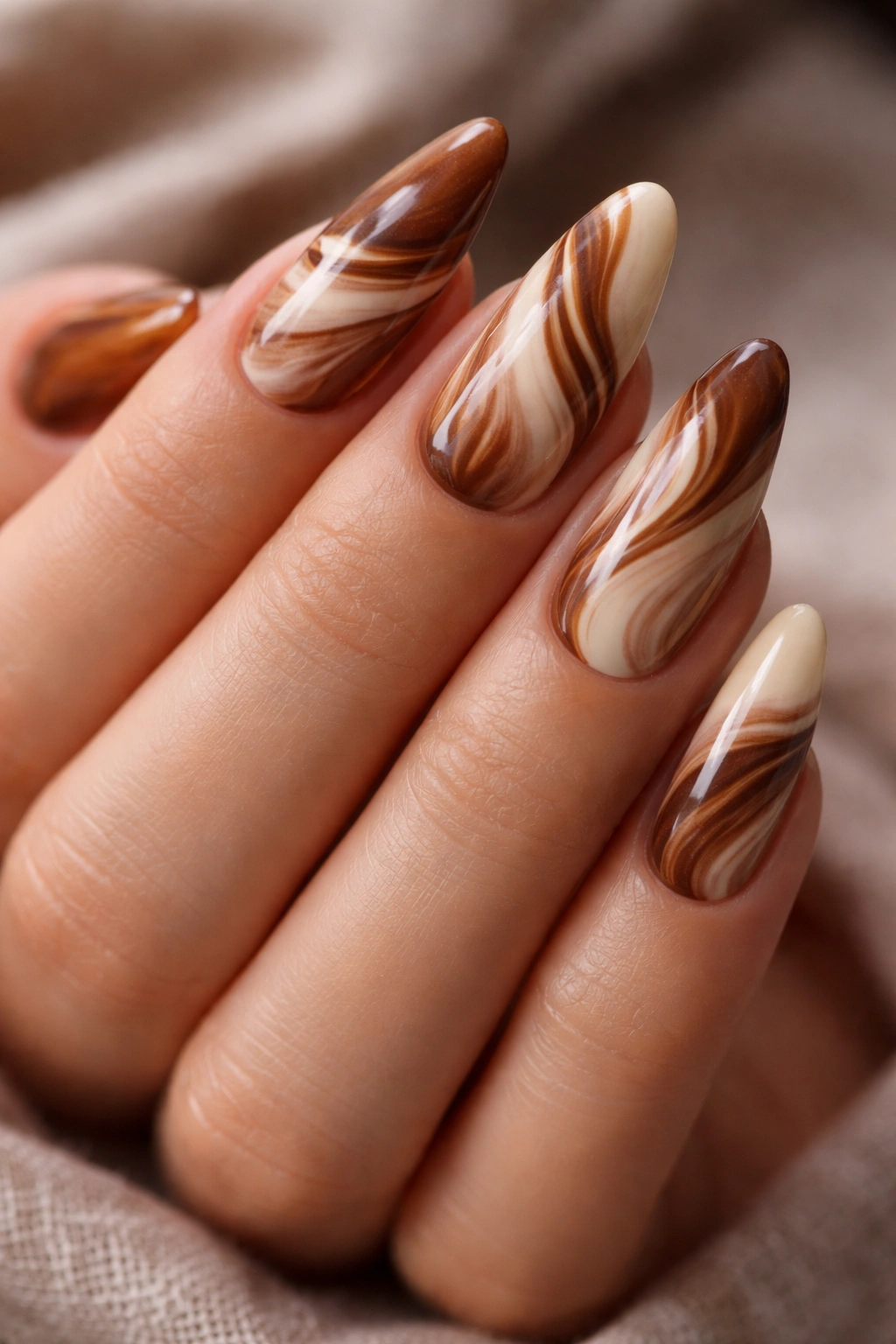 Cinnamon swirl marble almond nails close-up