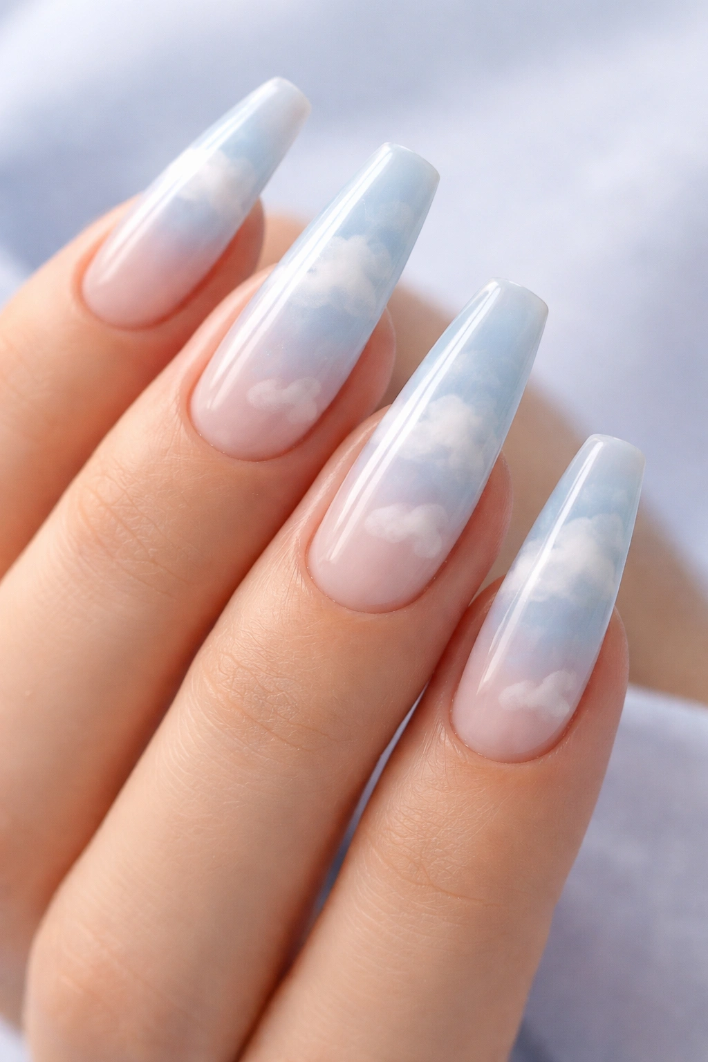 Sheer blue cloud nail art on ballerina nails