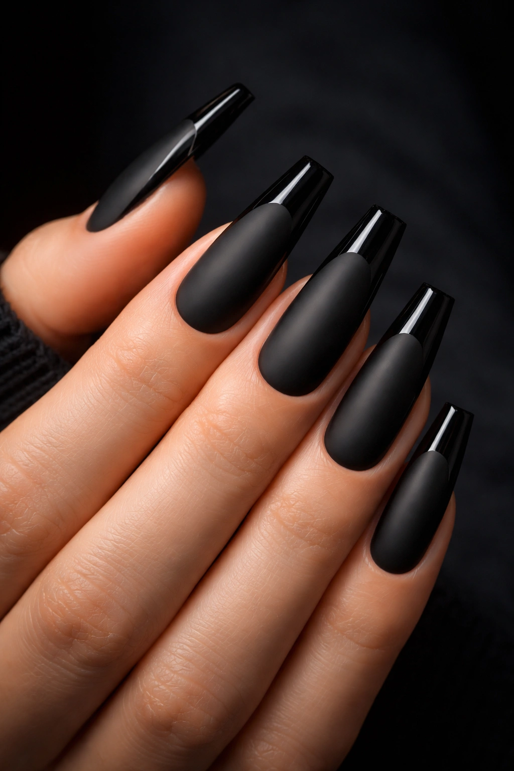 Close-up of matte black coffin nails with glossy tips