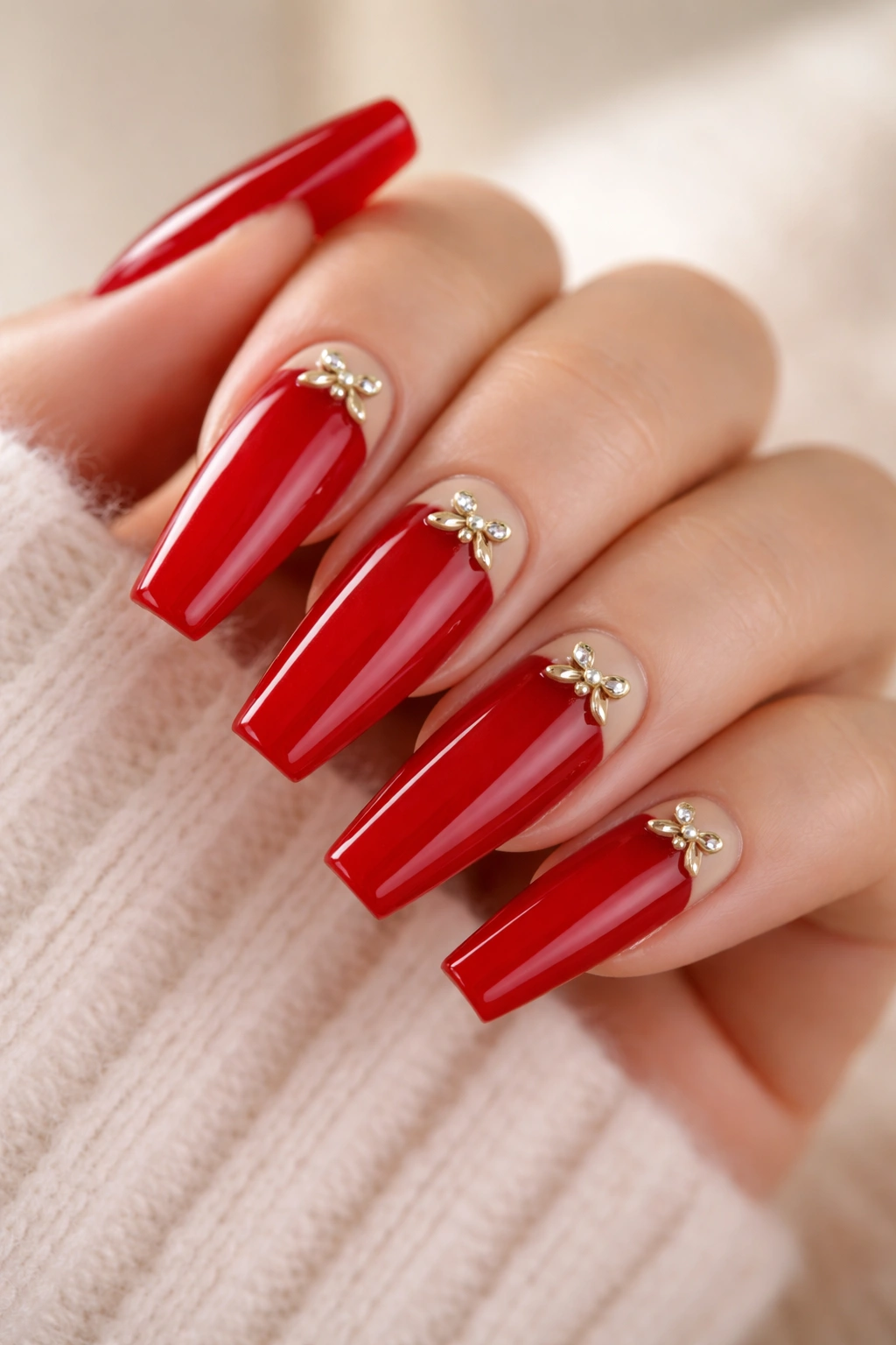 Close-up of classic red coffin nails with cuticle bow detail near the base