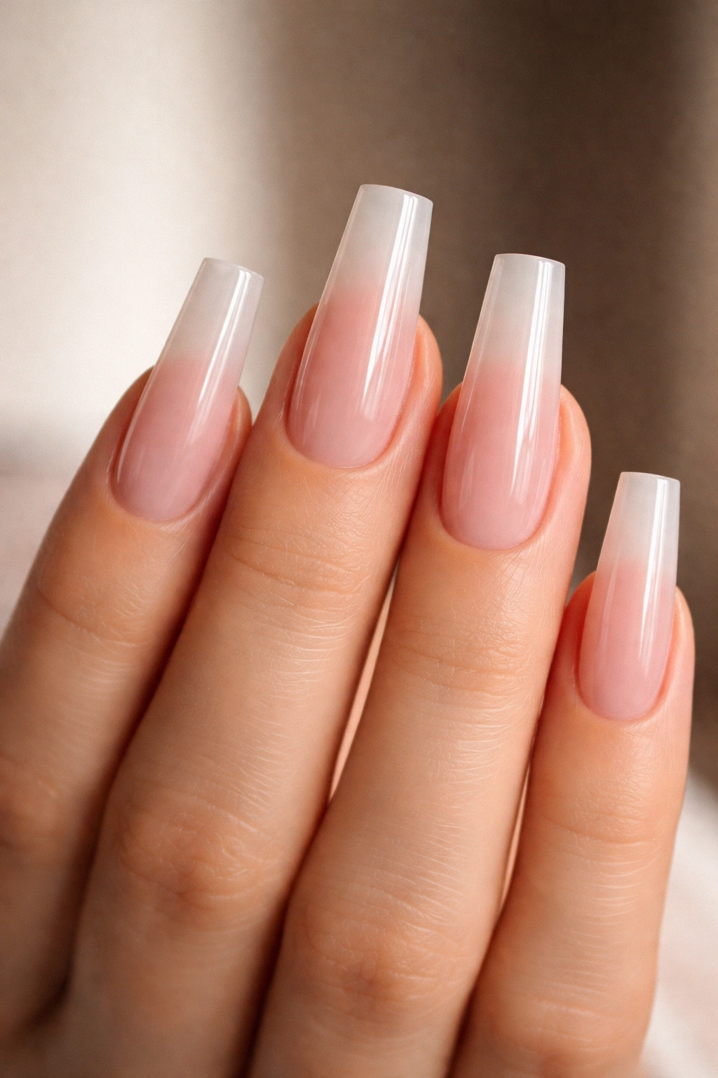 Close-up of long coffin nails with tapered square silhouette on a hand