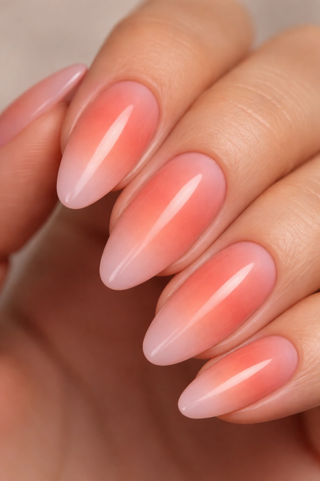 Almond nail with dusty coral center fading to pink edge.