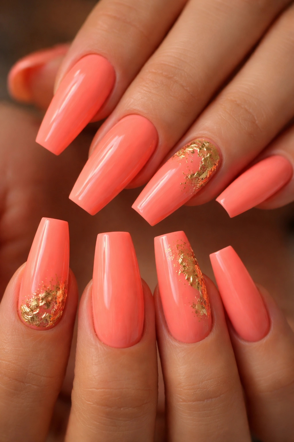 Close-up of coral coffin nails with gold foil flecks