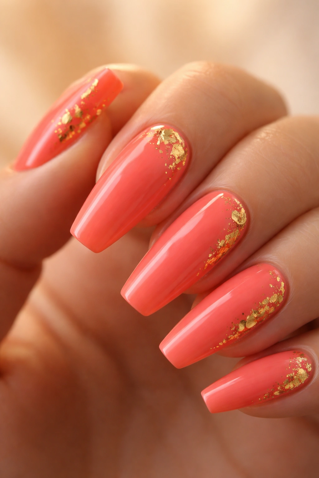 Close-up of coral coffin nails with small gold foil flecks