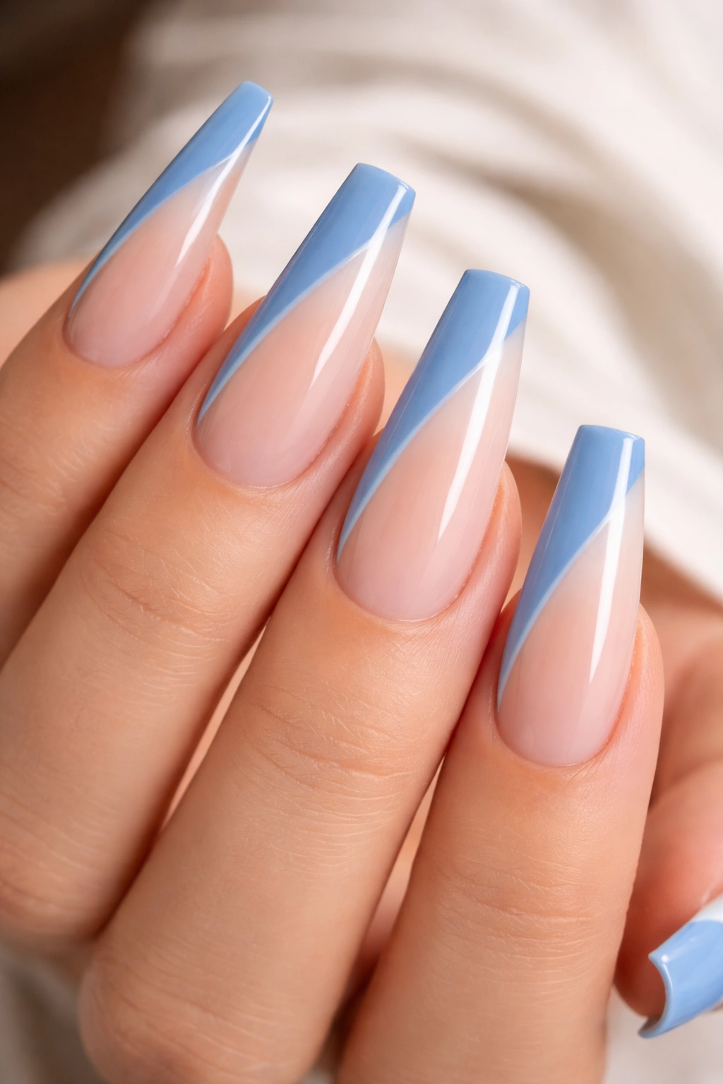 Cornflower blue side-French coffin nails with diagonal line on nude base