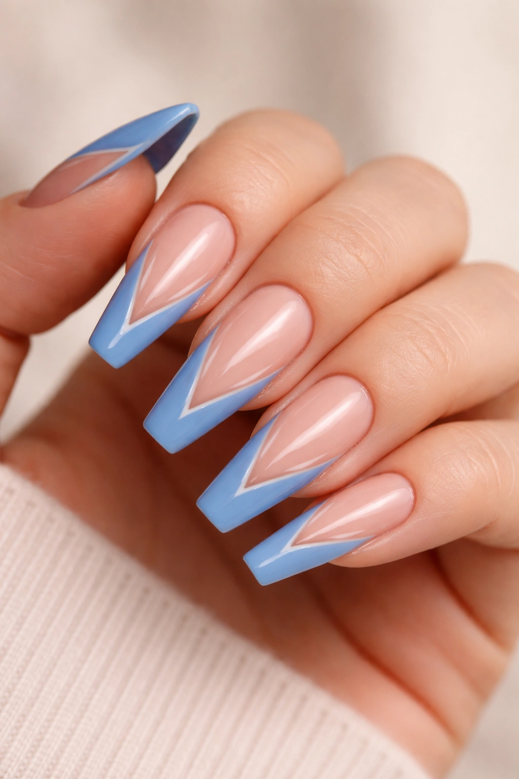 Close-up of coffin nails with cornflower blue V-tip and a negative-space cutout inside the V.