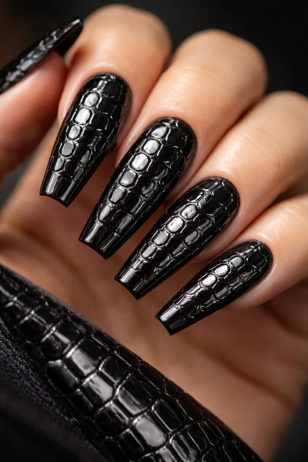 Close-up of croc-embossed black chrome coffin nails showing raised texture