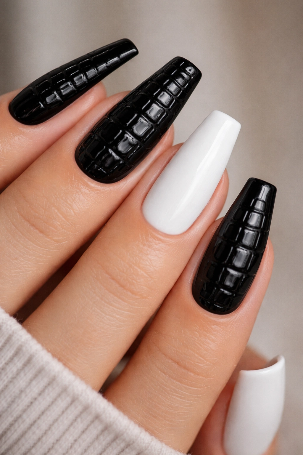 Croc texture black coffin nails with white accent nails on hand.