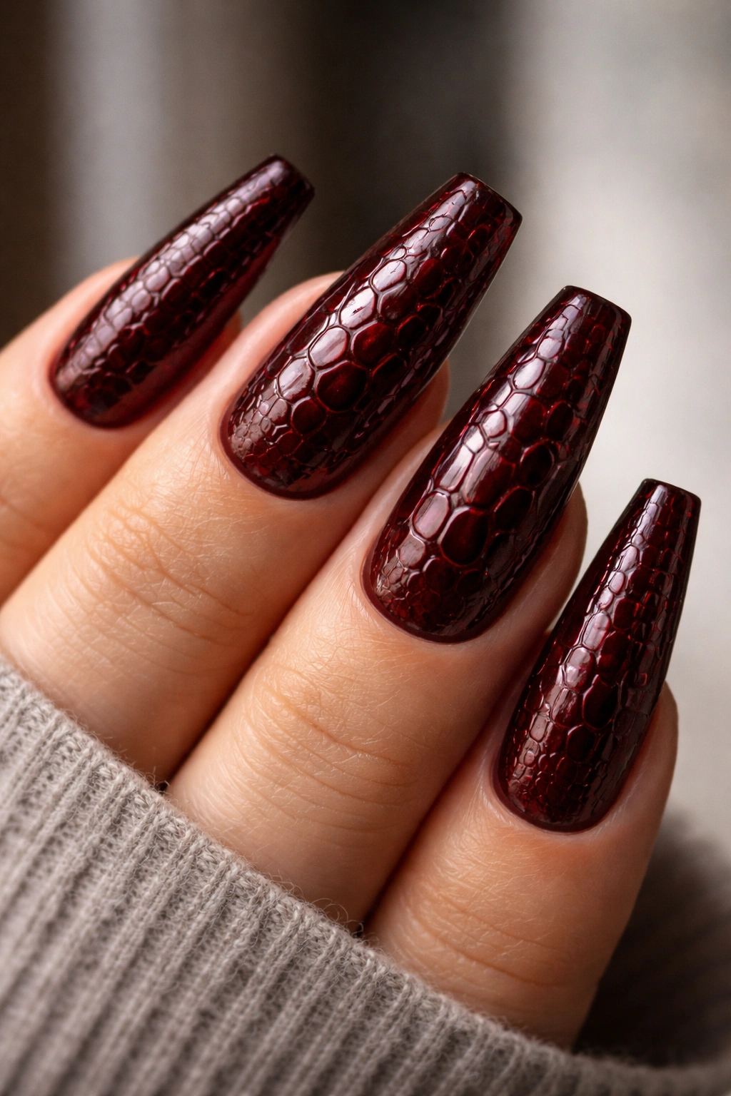 Croc-embossed dark red coffin nails with raised texture