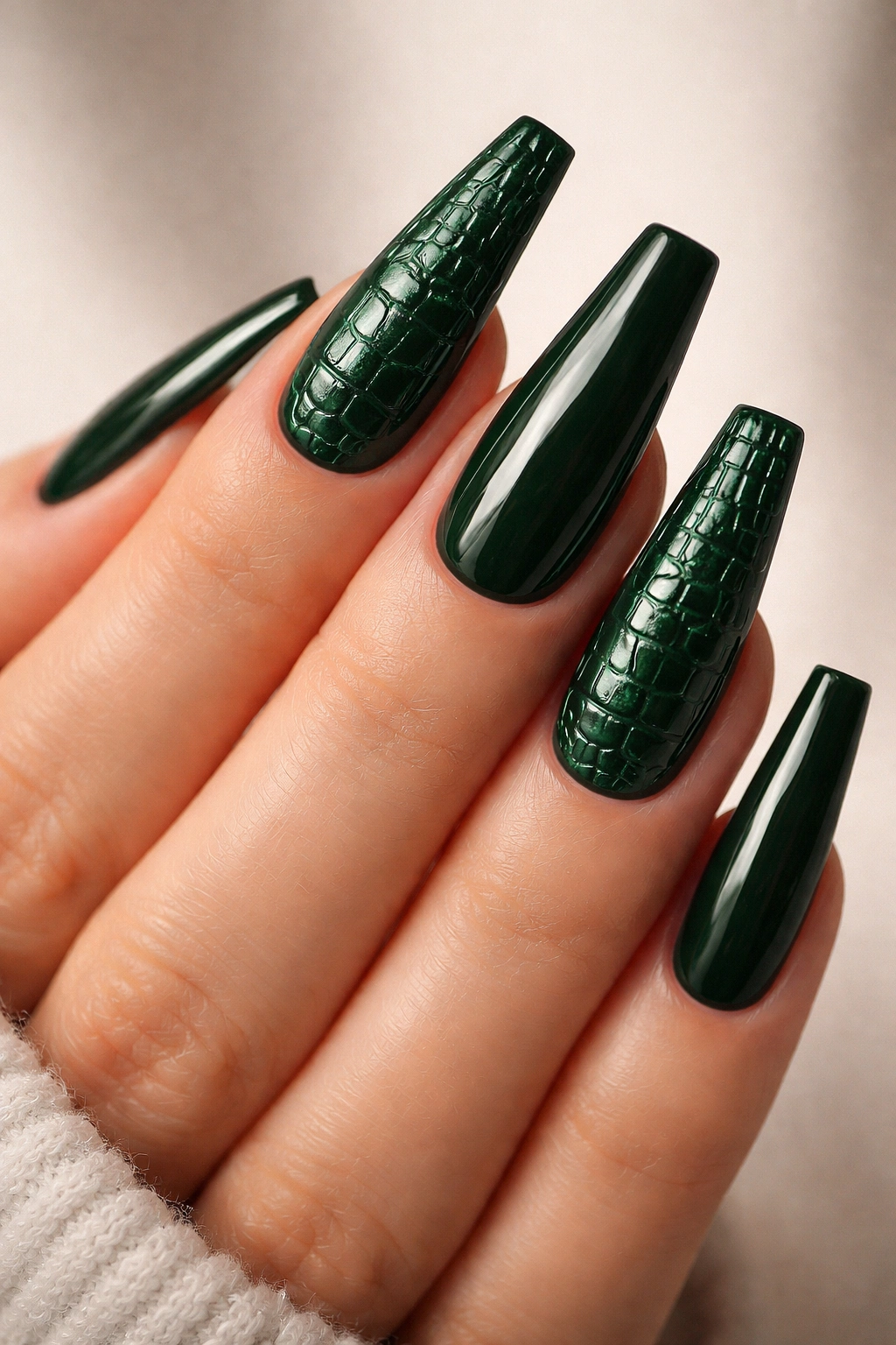 Close-up of coffin nails with crocodile texture in bottle green